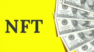 4k zoom in out NFT non-fungible token text. Concept words NFT non-fungible token on paper blank. Background of dollar bills. Blockchain asset crypto art, digital art, new type of cryptorurrency Money