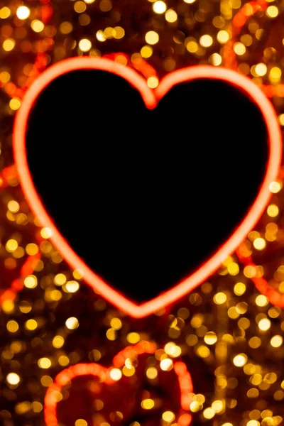 Defocused Heart in neon lights at night. Electric sign at night nightlife concept. Modern fluorescent life style luminescent. LED light sign color lighting