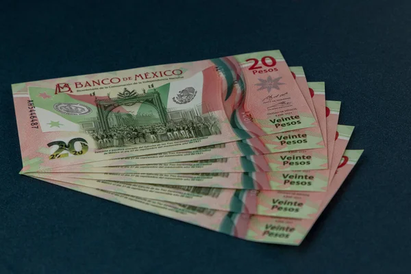 Several Mexican 20 peso bills arranged on a blue background, with space for text — 图库照片