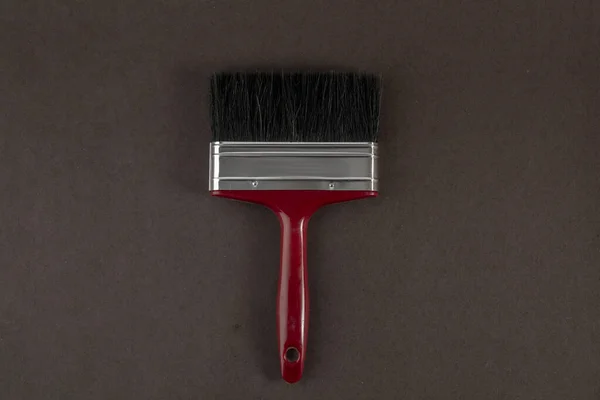 Flat lay of paint brush with brown background — Stock Photo, Image