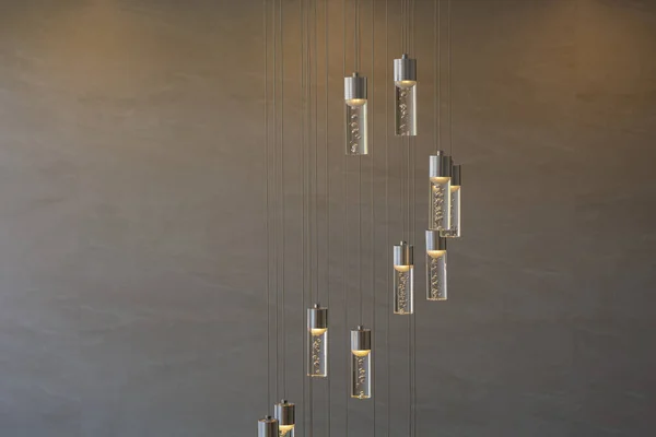 Indoor lamp lit in an apartment with a marble wall in the background