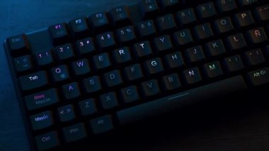 RGB lighting of mechanical keyboard on gamer desk