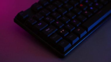 Mechanical keyboard on desk with purple lighting