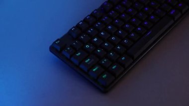 Mechanical keyboard panning with RGB lighting on a desk
