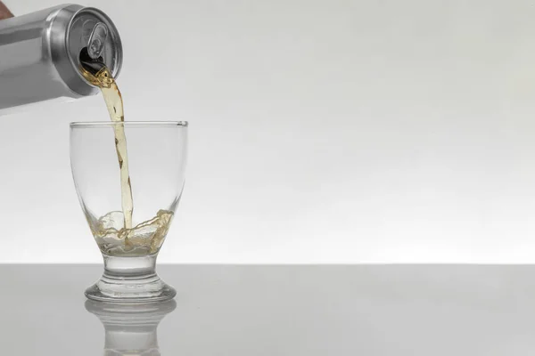 Serving a can of beer in a crystal glass with a white background and copy space — Stockfoto