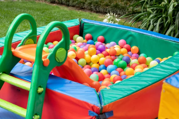 Colored ball pool with ladder for children to play. Childrens games in the garden.