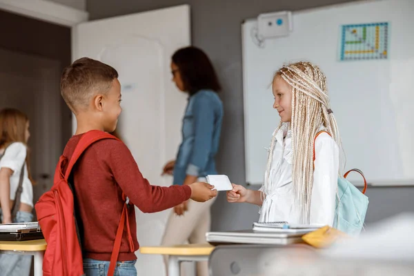 Feliz dos niños con mochilas de pie en clase — Foto de Stock