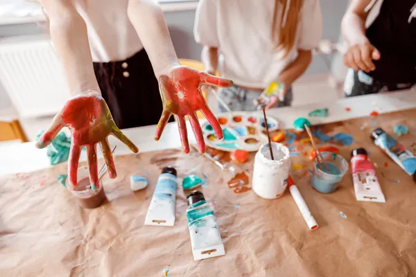 Kids are showing palms painted with watercolor — Stock Photo, Image