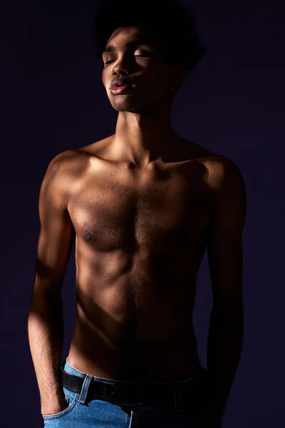 Portrait of transgender model with closed eyes stand in casual pose in shadow. Muscular trans gender — Stock Photo, Image