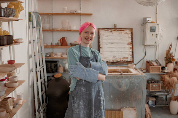 Female potter master working on craft in clay studio