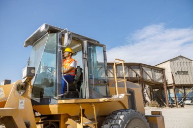 Fabrikada ağır makineler kullanan çok ırklı inşaat işçisi