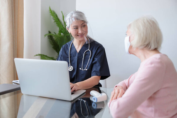 Retired patient with her doctor on appointment