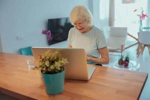 Wanita senior yang bekerja dengan laptop di rumah — Stok Foto