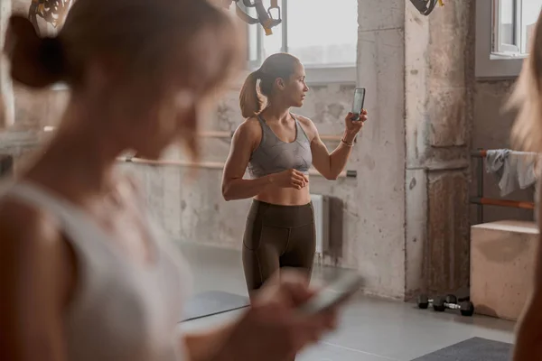 Hermosa atleta femenina de pie en el gimnasio — Foto de Stock