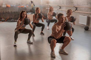 Spor salonundaki müşterileri ile profesyonel antrenör.