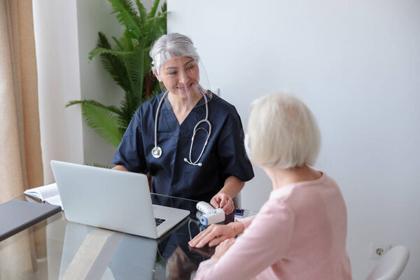 Medical specialist appointment eldery female in her apartment