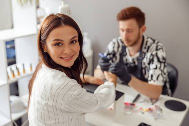 Beyaz kadın güzellik salonunda manikür yaptırıyor.