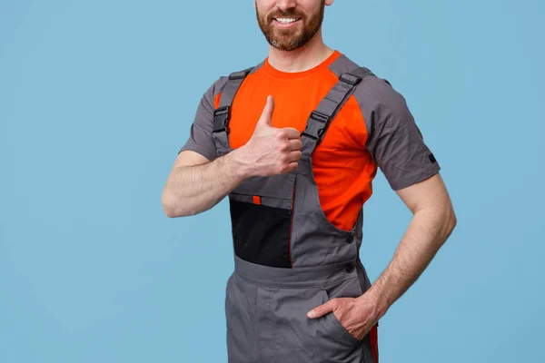 Unrecognizable smiling worker man In uniform showing thumbs up