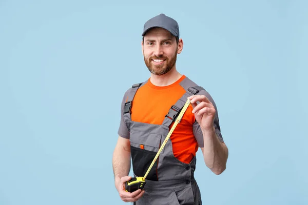 Smiling Repairman Worker Uniform Holding Measure Tape Yellow Background Studio — Stock Photo, Image