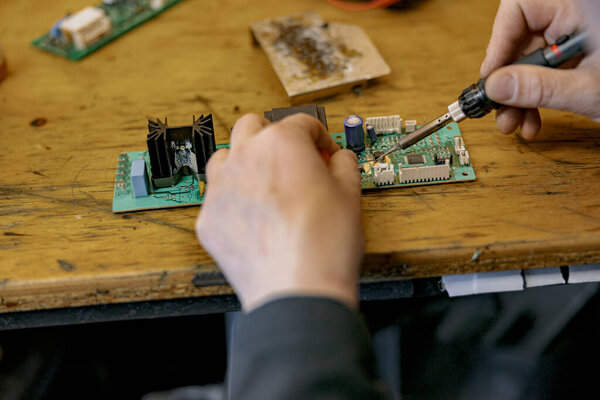 Close Repairman Hands Soldering Circuit Board Electronic Device Table Workshop Stock Image