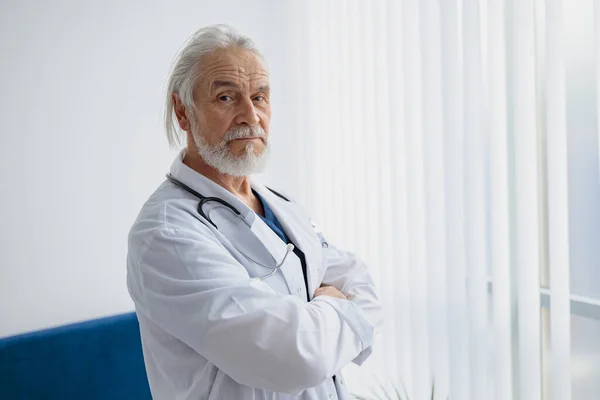 Portrait of doctor in uniform standing in medicine clinic and looking camera. High quality photo
