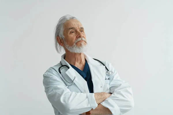 Portrait of doctor in uniform standing in medicine clinic hall and looking away. High quality photo