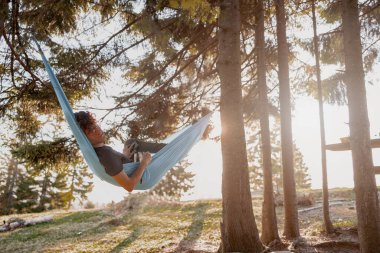 Ormanda uyuyan ve dinlenen erkek hamak. Güzel doğa. Tahtada dinleniyor. Vahşi turizm. Dinlen..