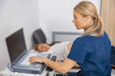 Doktor ultrason hastanede hastanın karnını muayene ediyor. Doğum öncesi teşhis merkezi. Yüksek kalite fotoğraf