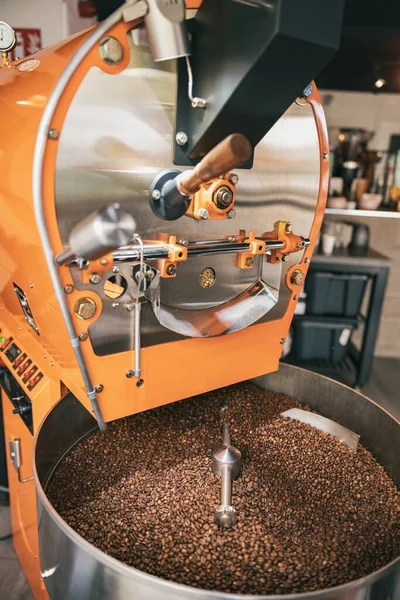 Close up of coffee roasting machine with beans in small coffee manufacturing. High quality photo
