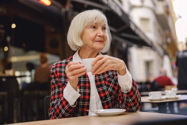 Thoughtful Senior Woman Wearing Fashionable Plaid Jacket Looking Side While — Stok Foto