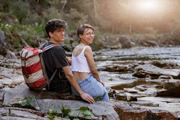 Portrait Couple Hikers Sitting Rocks Mountains River Turning Camera Rear — Stok fotoğraf