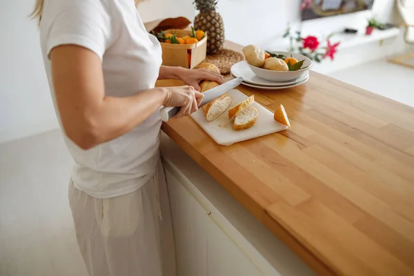 Caucasian Woman Cutting Slides Baguette Kitchen Morning Making Breakfast Close — Stok fotoğraf