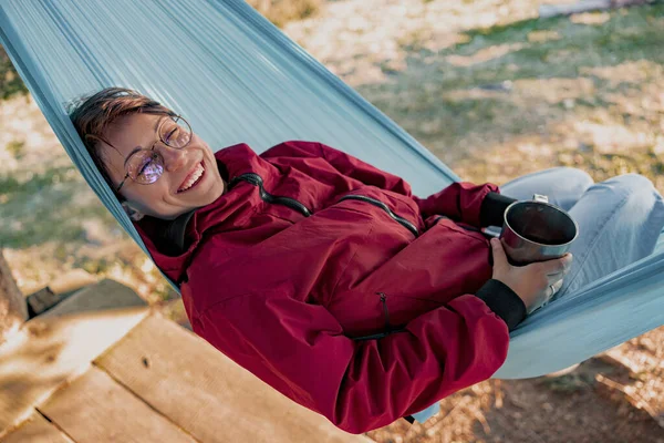 Portrait Young Cheerful Happy Woman Glasses Lying Hammock Smiling Holding — Stockfoto