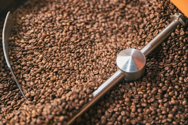 Close up of coffee beans in coffee roasting machine in a small manufacturing. High quality photo