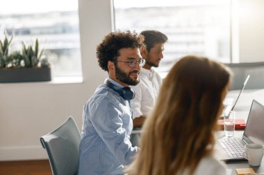 Group of coworkers working together analyzing the charts in office. Blurred background