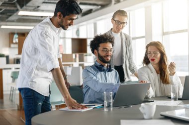 Coworkers cooperating and working together at office meeting, teamwork concept. Blurred background