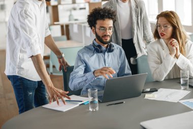 Coworkers cooperating and working together at office meeting, teamwork concept. Blurred background