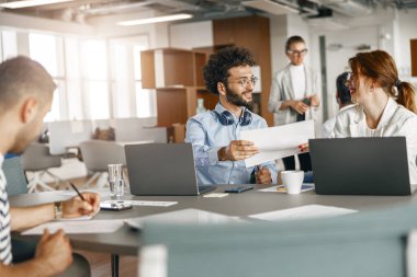 Coworkers cooperating and working together at office meeting, teamwork concept. High quality photo