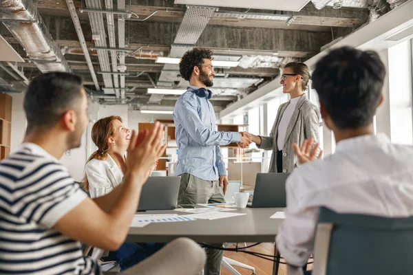 Female boss leader shaking hand of new team member recruiting him for job on staff briefin