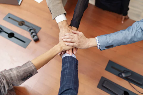 Group of coworkers stacked hands together as concept of corporate unity. High quality photo