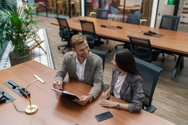 Two businesspartners working laptop together in modern coworking. High quality photo