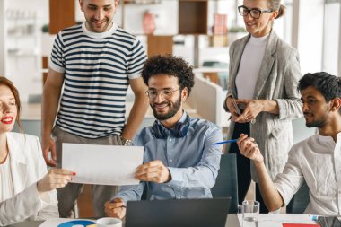 Coworkers cooperating and working together at office meeting, teamwork concept. Blurred background