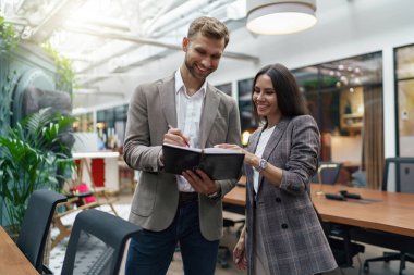 Businesspeople talking while standing in office during break. Teamwork concept. High quality photo