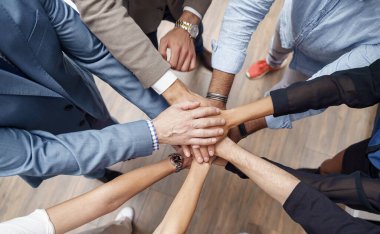 Group of coworkers stacked hands together as concept of corporate unity. High quality photo