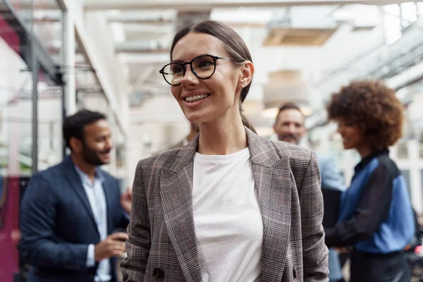 Smiling Businesswoman Standing Modern Office Colleagues Background Looking Side — Stok Foto