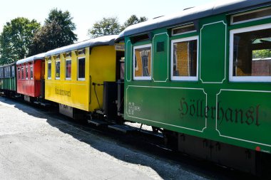 Stainz, Avusturya - 23 Eylül 2021: Flascherlzug adı verilen trenin renkli vagonları - şişe treni - dar bir demiryolu ve Batı Styria 'da popüler bir turistik eğlence merkezi, her vagonun farklı bir adı vardır.
