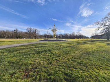 Laxenburg, Austria - January 02, 2022: Fountain that become illuminated in the evening in the public castle park of Laxenburg