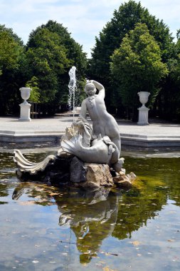 Vienna, Austria - August 01, 2022: Western Naiad fountain with sculpture - former residence of the Habsburg rulers and today a UNESCO World Heritage Site, world-famous tourist attraction situated in a large park landscape with the oldest zoo in the w