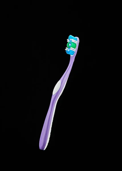 Purple toothbrush isolated on black background — Stock Photo, Image
