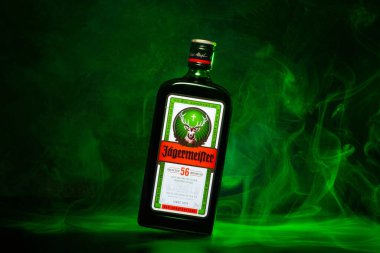 Ukrayna, Poltava - 11 Temmuz 2022: 56 bitki ve baharatla yapılmış bir şişe Jagermeister, Alman sindirimi. Yeşil dumanlı şişe